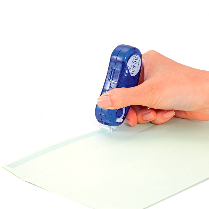 Applying tape to scrapbook layout with Norino Pod